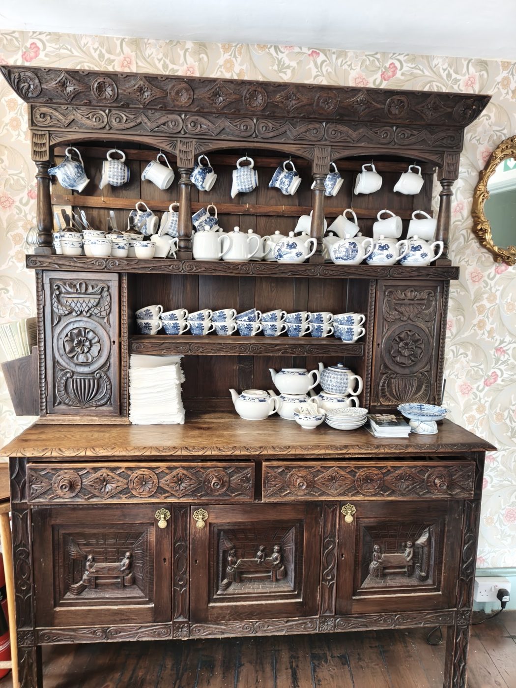 A wooden dresser filled with china